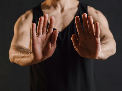 Detail of hands folded in a peaceful yoga mudra.